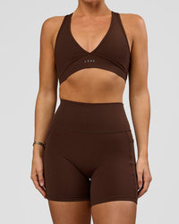 Woman wearing O.G. Fusion Ultra High-Rise 6" Short Pockets - Hot Chocolate | Model:Amity | Size:S | Thumbnail Index: 0