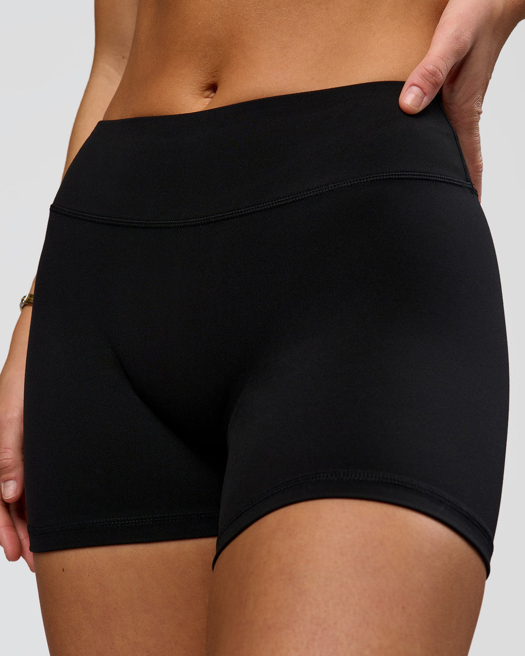Woman wearing RXD Mid-Rise 4" Short - Black | Model:Amity | Size:S - view 1