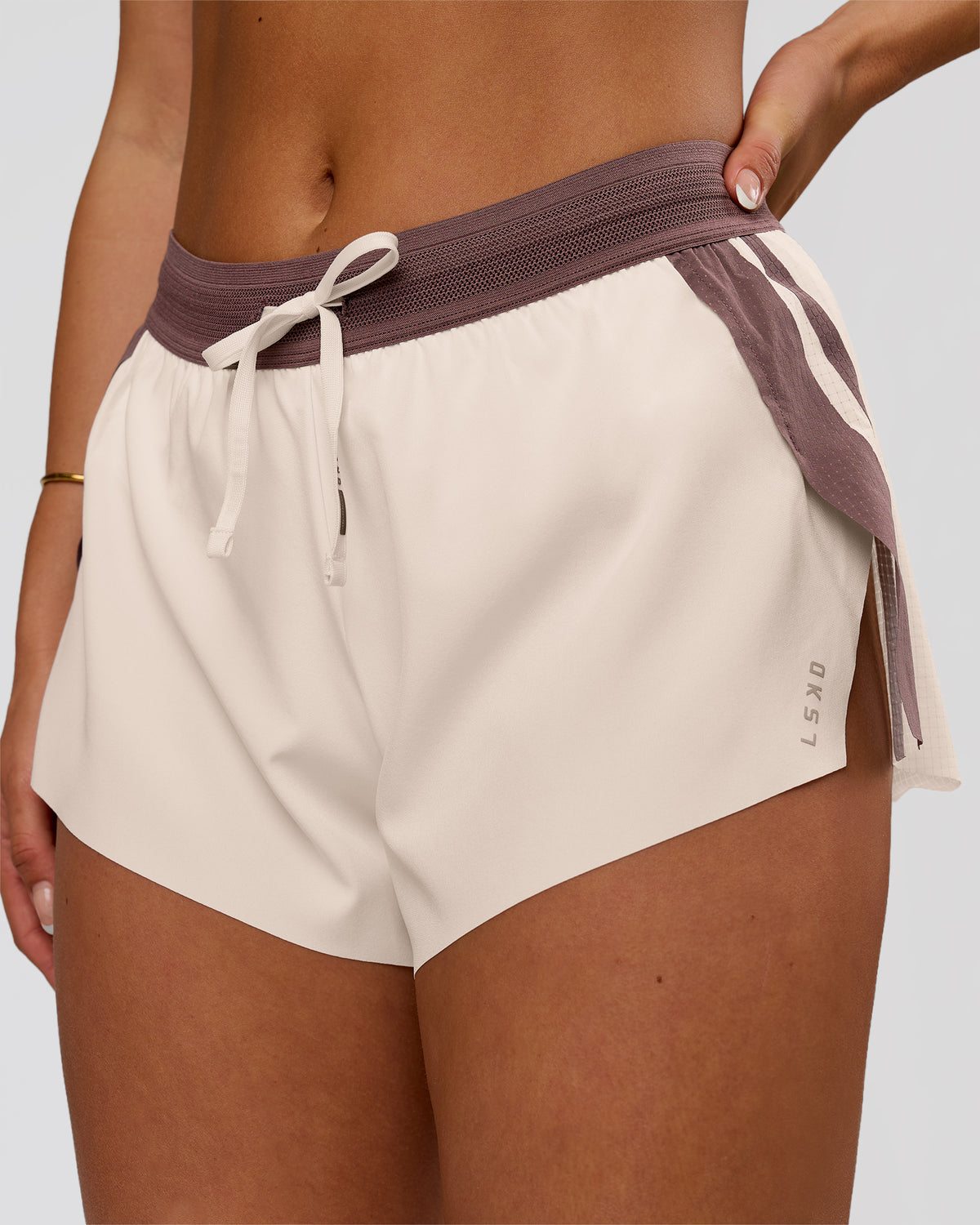 Woman wearing Accelerate 3" Force Mid-Rise Running Short - Cocoa powder-Off White | Model:Bianca | Size:S - view 1