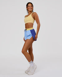 Woman wearing Accelerate 3" High-Rise Running Short - Power Cobalt-Open Air-Lemon | Model:Bianca | Size:S | Thumbnail Index: 1