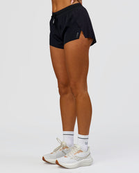 Woman wearing Accelerate 3" Mid-Rise Running Short - Black | Model:Bianca | Size:S | Thumbnail Index: 1