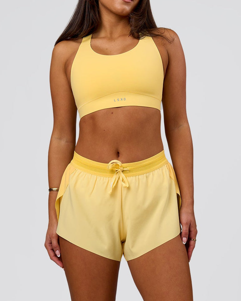 Woman wearing Accelerate 3" Mid-Rise Running Short - Sunbeam-Lemon | Model:Bianca | Size:S
