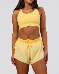 Woman wearing Accelerate 3" Mid-Rise Running Short - Sunbeam-Lemon | Model:Bianca | Size:S | Thumbnail Index: 1