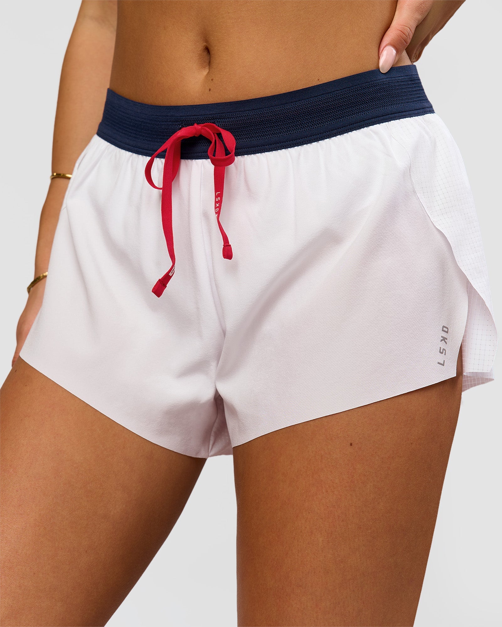 Woman wearing Accelerate 3" Mid-Rise Running Short - White-Future Navy | Model:Bianca | Size:S