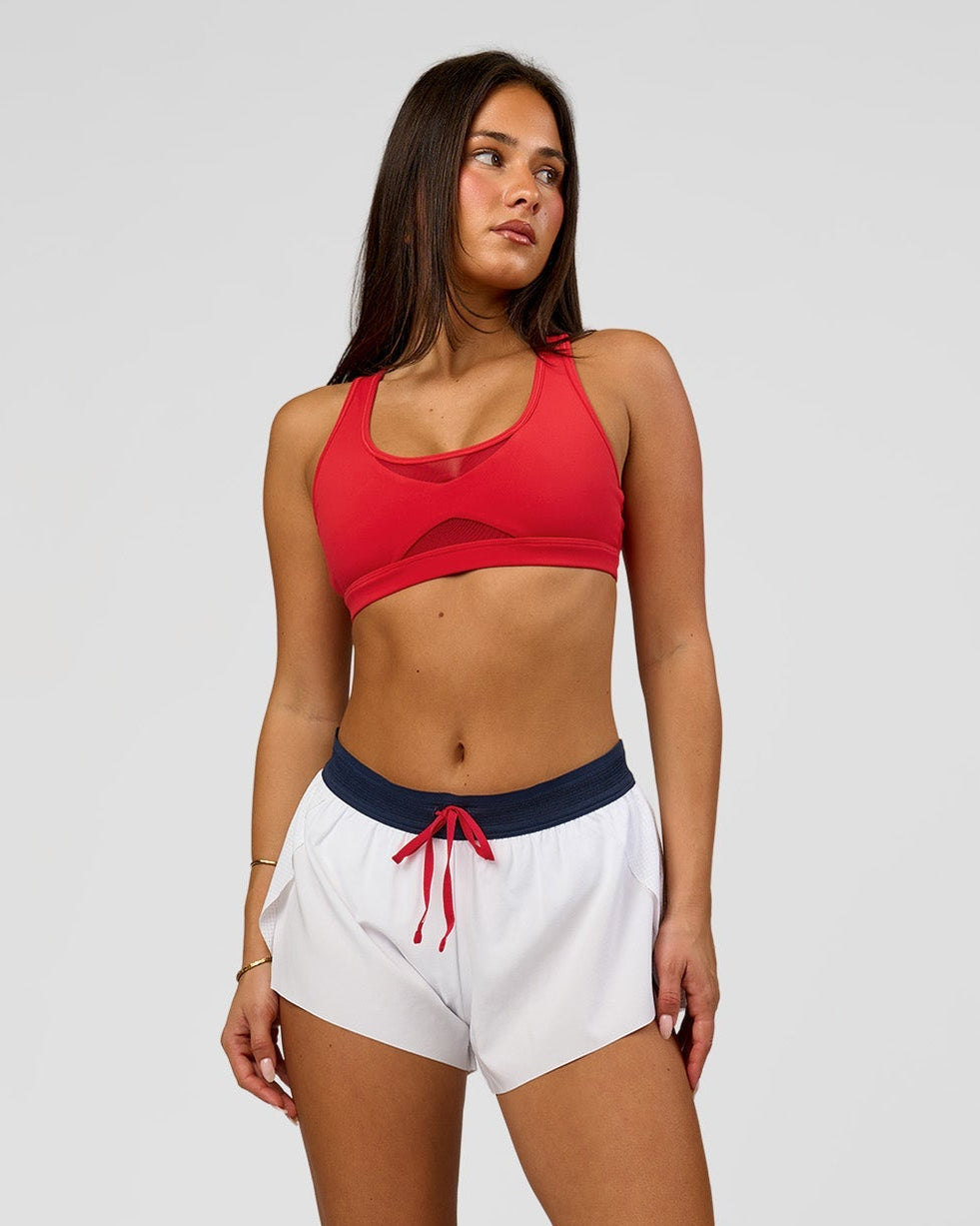 Woman wearing Accelerate 3" Mid-Rise Running Short - White-Future Navy | Model:Bianca | Size:S