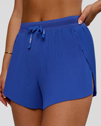 Woman wearing Accelerate 3" Pleated High-Rise Running Short - Power Cobalt | Model:Bianca | Size:S | Thumbnail Index: 0