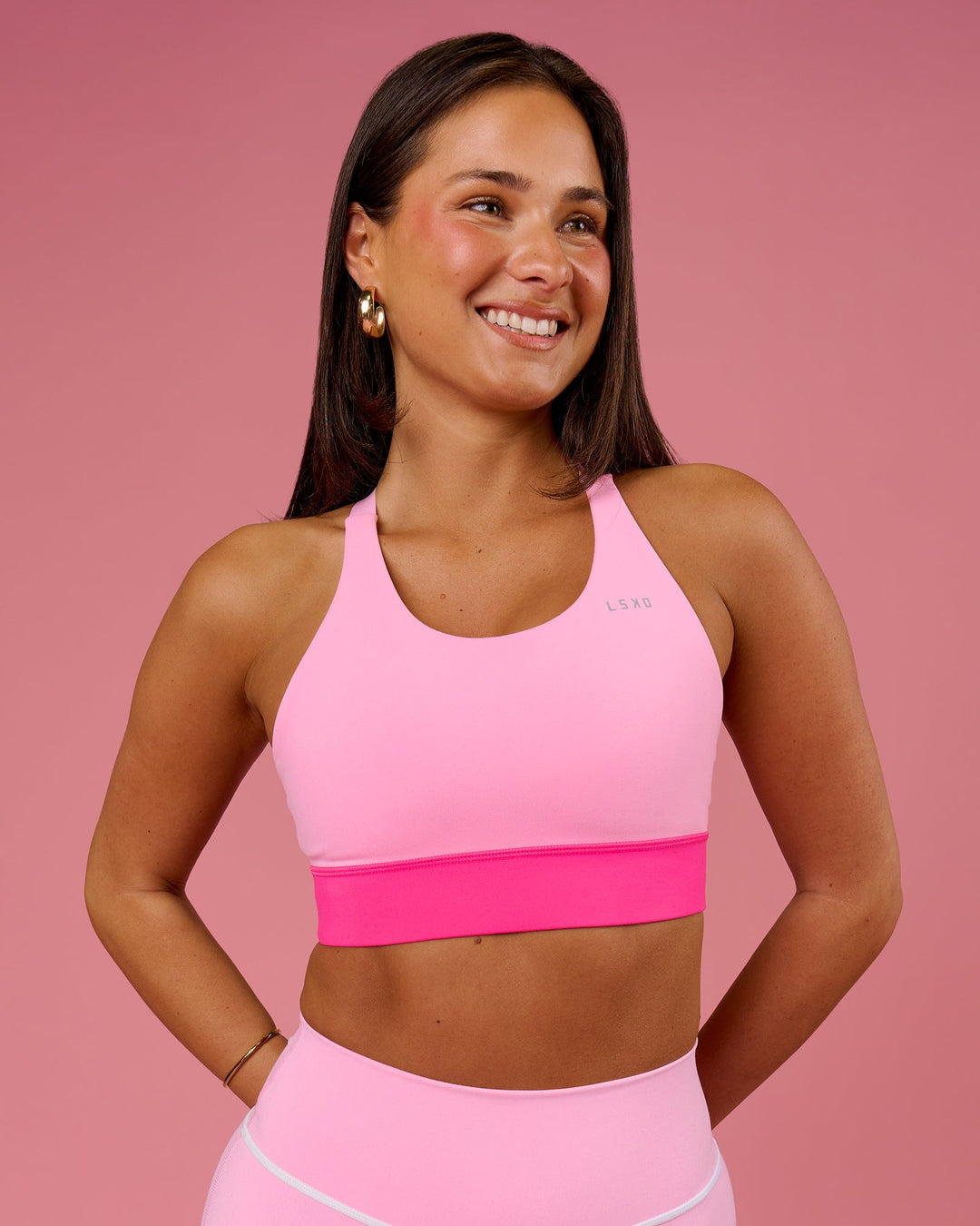 Woman wearing Accelerate Split Strap Sports Bra - Pink Rose-Ultra Pink | Model:Bianca | Size:S - view 1