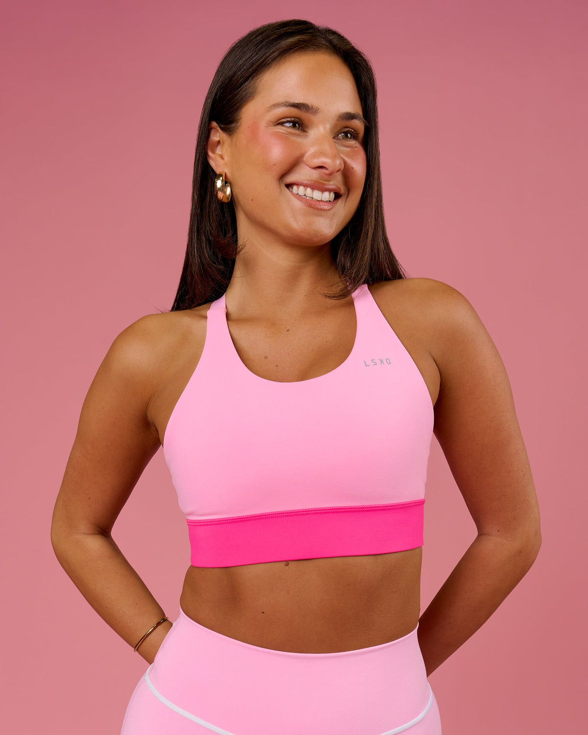 Woman wearing Accelerate Split Strap Sports Bra - Pink Rose-Ultra Pink | Model:Bianca | Size:S