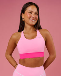 Woman wearing Accelerate Split Strap Sports Bra - Pink Rose-Ultra Pink | Model:Bianca | Size:S | Thumbnail Index: 0