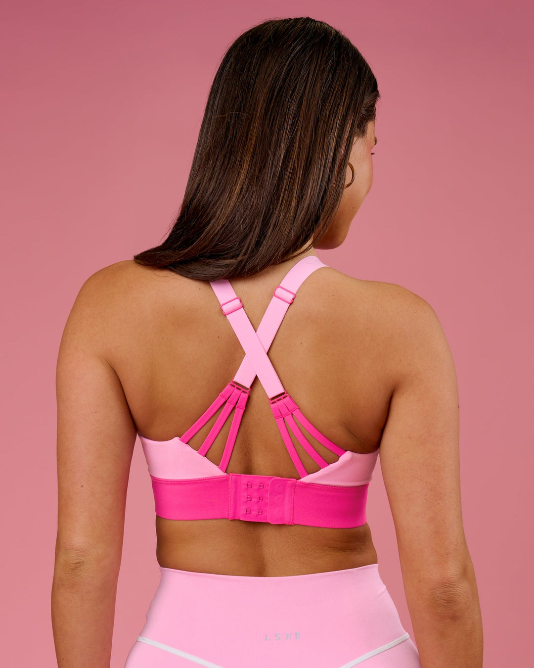 Woman wearing Accelerate Split Strap Sports Bra - Pink Rose-Ultra Pink | Model:Bianca | Size:S - view 2