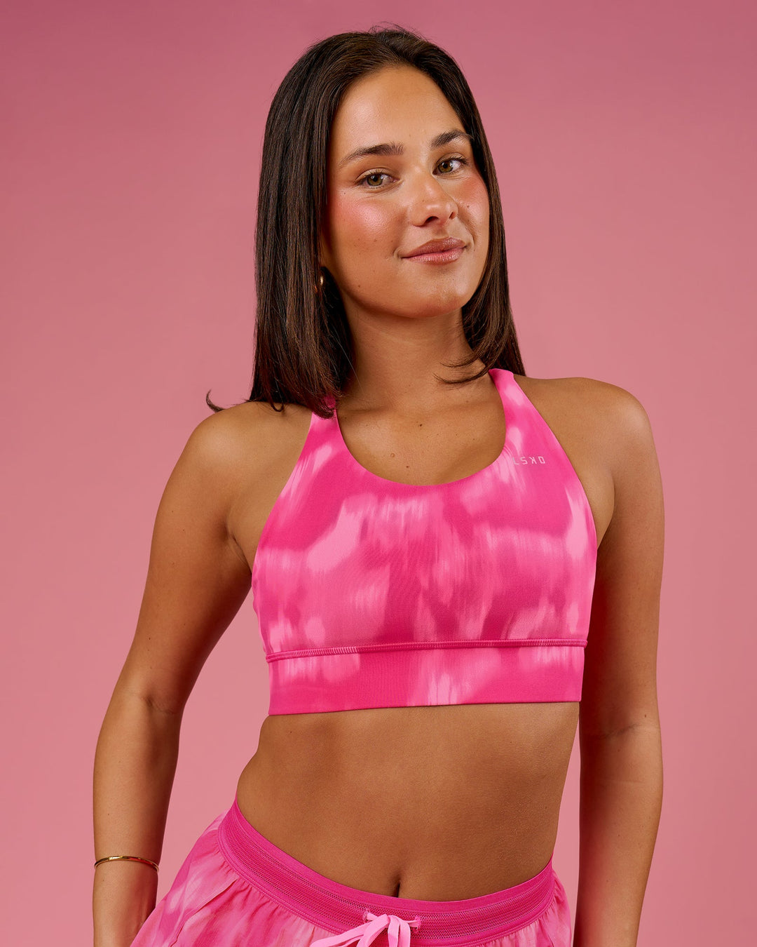 Woman wearing Accelerate Sports Bra - Radiant Pink | Model:Bianca | Size:S - view 1