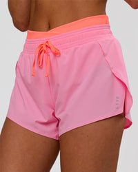 Woman wearing Accelerate Synergy 3" Running Short Short - Pink Rose-Hyper Orange | Model:Bianca | Size:S | Thumbnail Index: 0