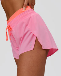 Woman wearing Accelerate Synergy 3" Running Short Short - Pink Rose-Hyper Orange | Model:Bianca | Size:S | Thumbnail Index: 2