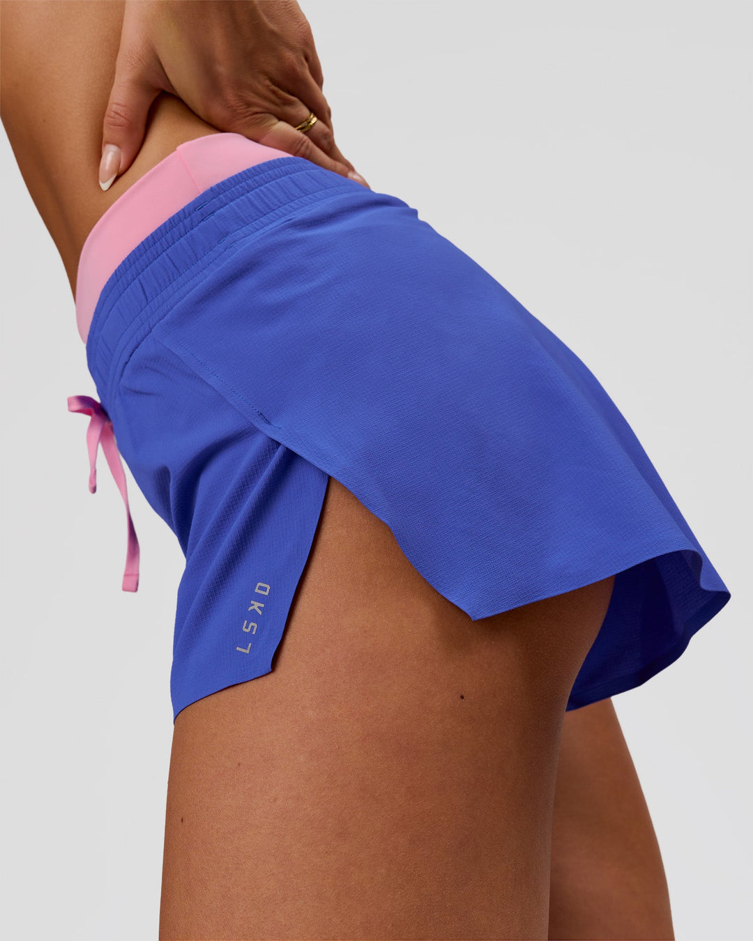 Woman wearing Accelerate Synergy 3" Running Short Short - Power Cobalt-Pink Rose | Model:Bianca | Size:S - view 9