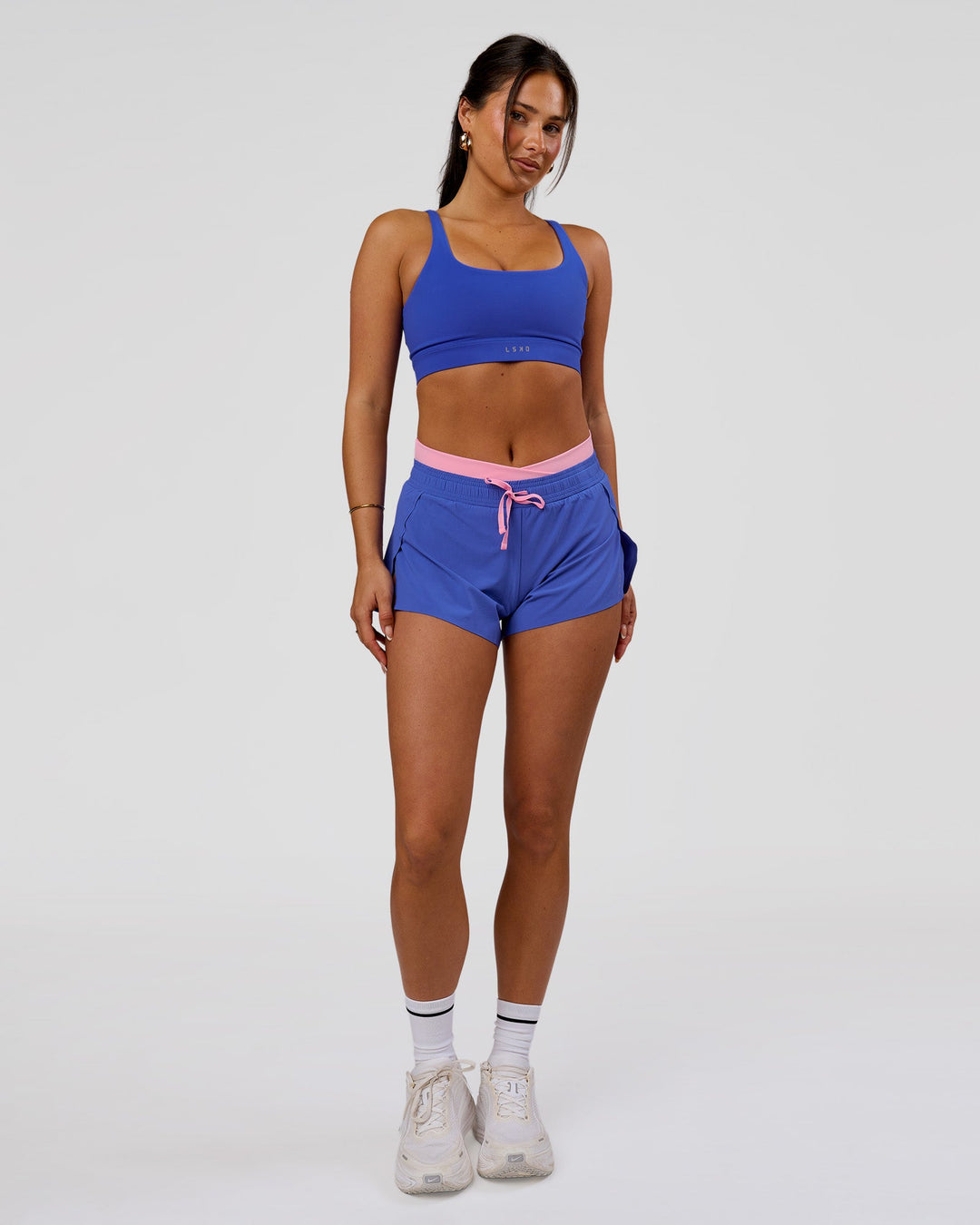 Woman wearing Accelerate Synergy 3" Running Short Short - Power Cobalt-Pink Rose | Model:Bianca | Size:S - view 12