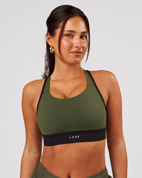 Woman wearing Distinction Sports Bra 2.0 - Pure Olive-Black | Model:Bianca | Size:S | Thumbnail Index: 0