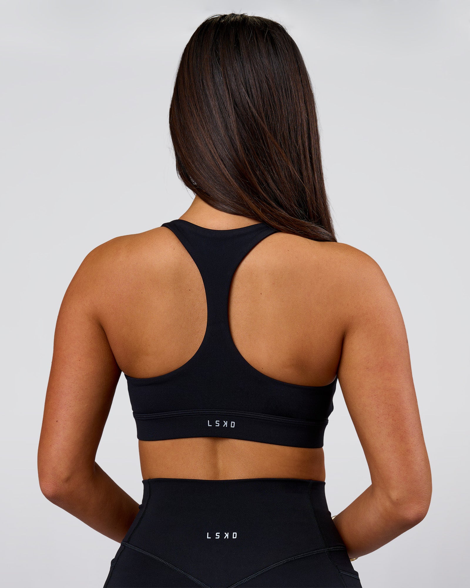 Woman wearing Flow Sports Bra - Black | Model:Bianca | Size:S
