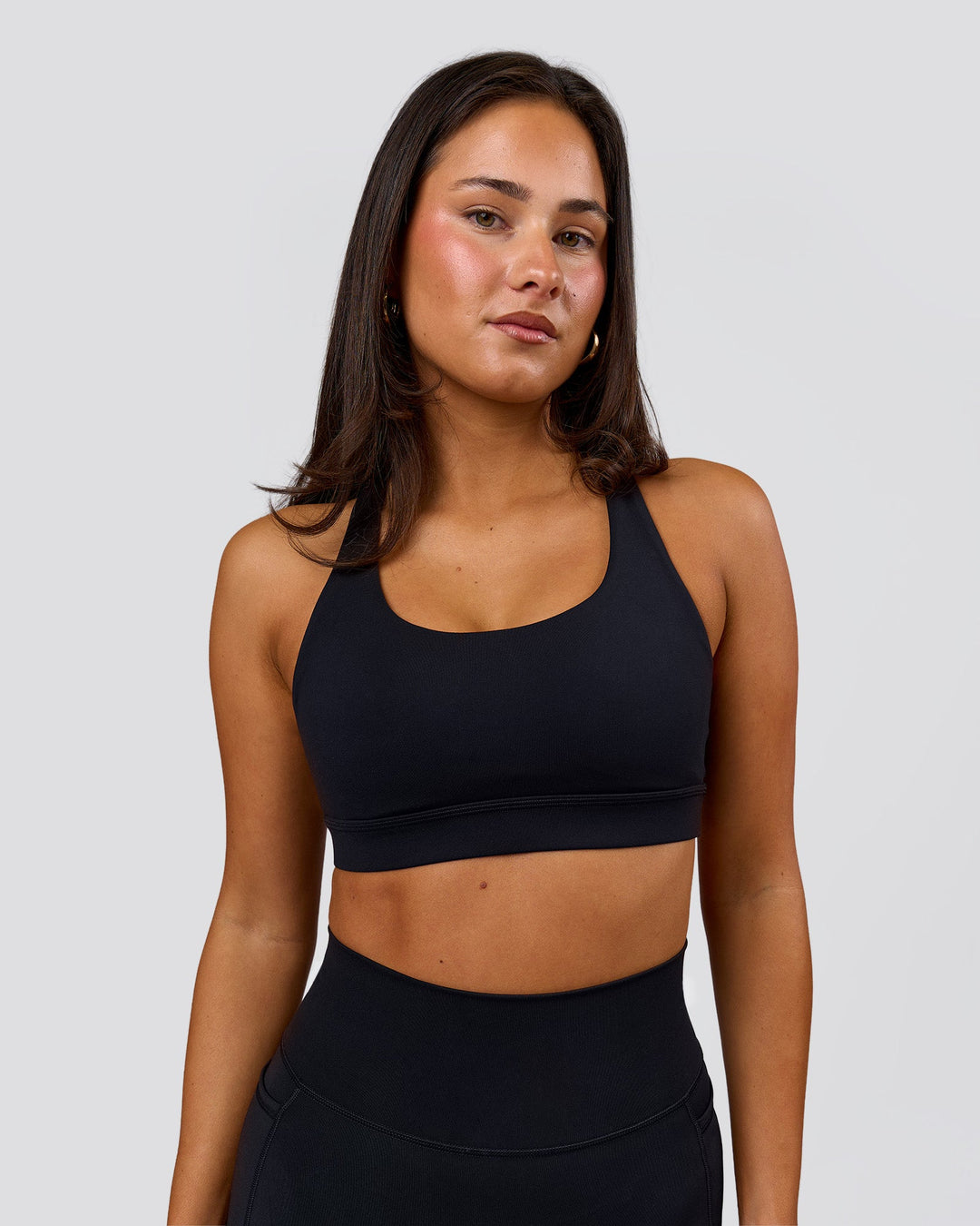 Woman wearing Flow Sports Bra - Black | Model:Bianca | Size:S - view 1