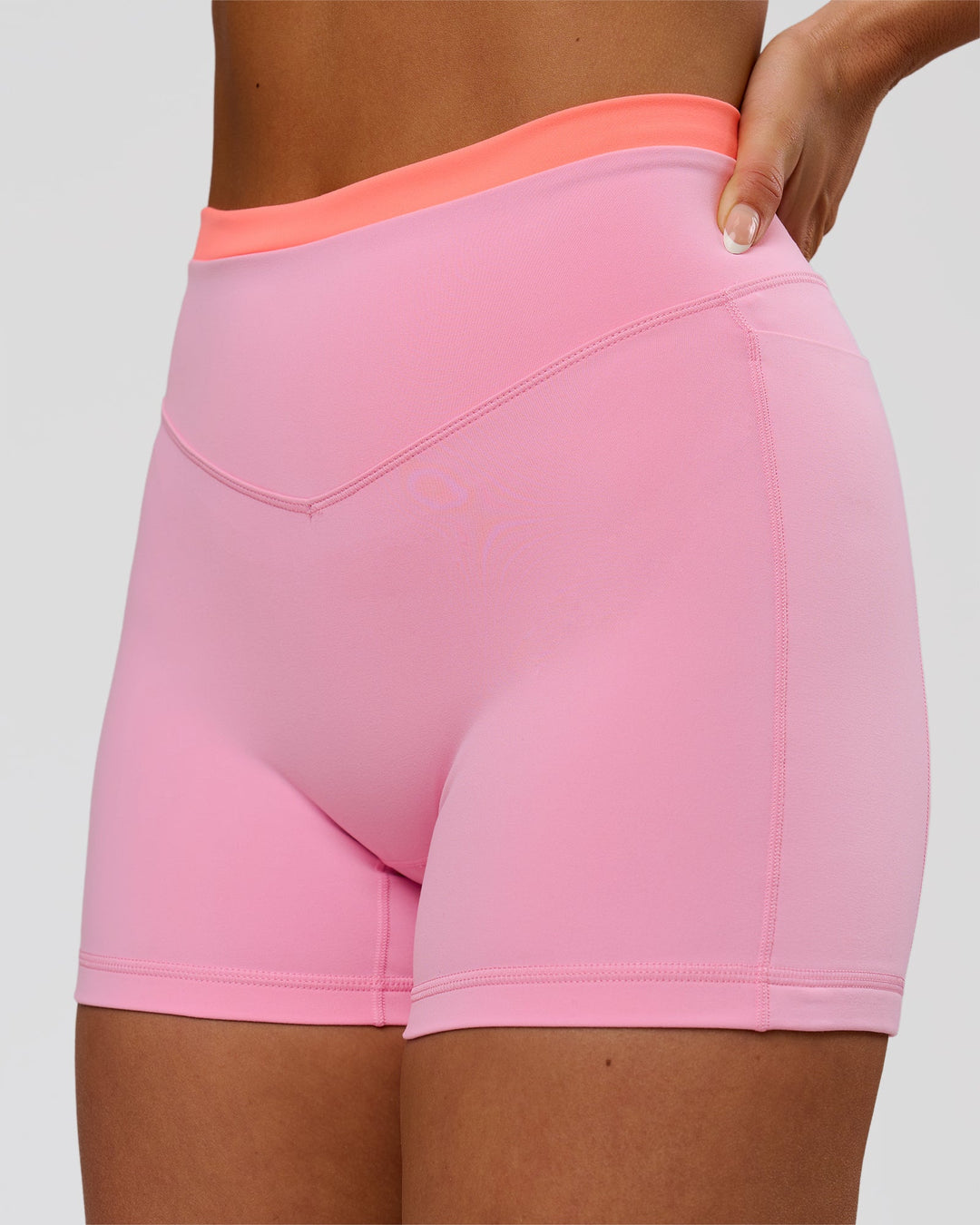 Woman wearing Fusion Contrast V-Waist High-Rise 4" Short Pockets - Pink Rose-Hyper Orange | Model:Bianca | Size:S - view 1