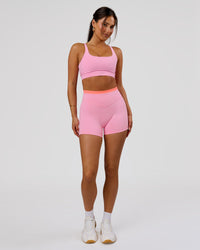 Woman wearing Fusion Contrast V-Waist High-Rise 4" Short Pockets - Pink Rose-Hyper Orange | Model:Bianca | Size:S | Thumbnail Index: 1