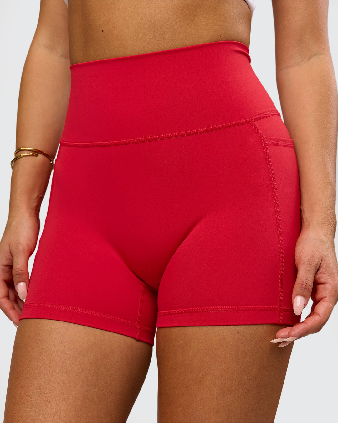 Woman wearing Fusion Ultra High-Rise 4" Short Pockets - Scarlet | Model:Bianca | Size:S - view 2