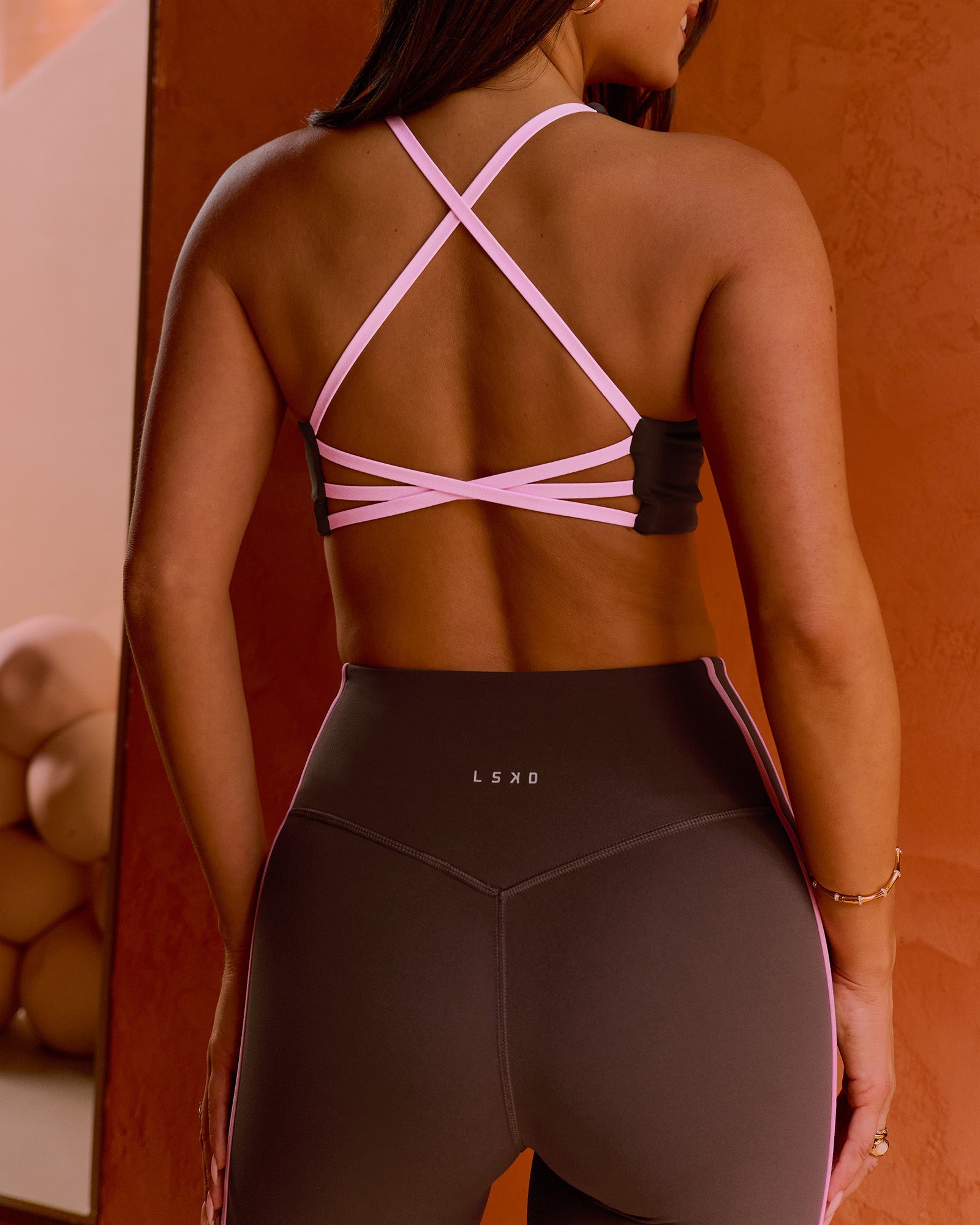 Woman wearing Stellar Sports Bra - Hot Chocolate-Pink Rose | Model:Bianca | Size:S