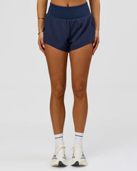 Woman wearing Tia-Clair Toomey-Orr Accelerate 3" Storage Running Short - Future Navy | Model:Bianca | Size:S | Thumbnail Index: 6