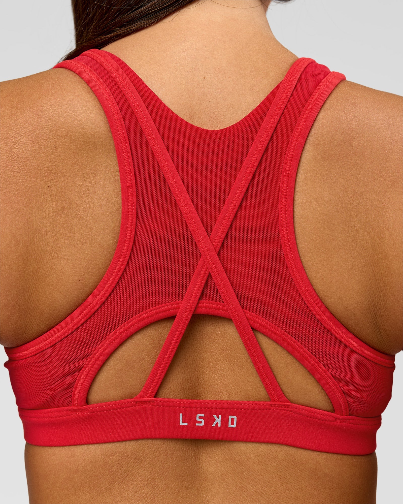 Woman wearing Unstoppable Racerback Sports Bra - Scarlet | Model:Bianca | Size:S