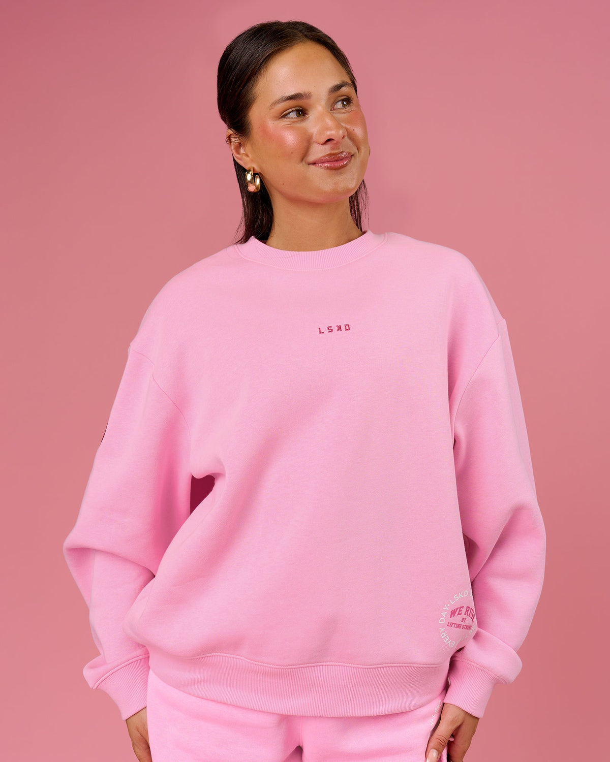 Woman wearing We Rise Oversized Sweater - Pink Rose-We Rise | Model:Bianca | Size:S