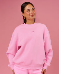 Woman wearing We Rise Oversized Sweater - Pink Rose-We Rise | Model:Bianca | Size:S | Thumbnail Index: 0