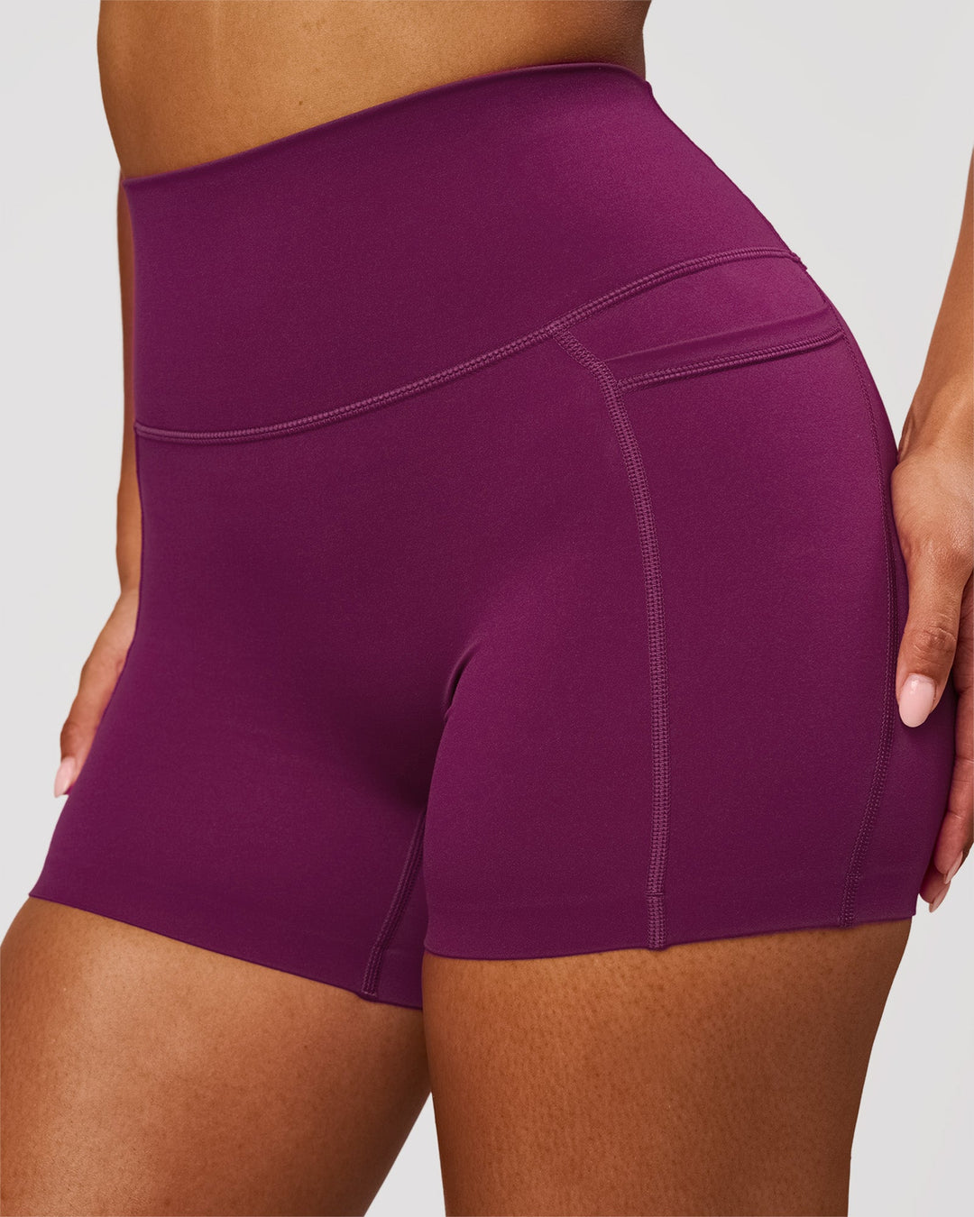 Woman wearing Elixir High-Rise 4" Short Pockets - Plum Caspia | Model:Jordan | Size:S - view 1