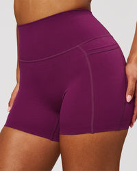 Woman wearing Elixir High-Rise 4" Short Pockets - Plum Caspia | Model:Jordan | Size:S | Thumbnail Index: 0