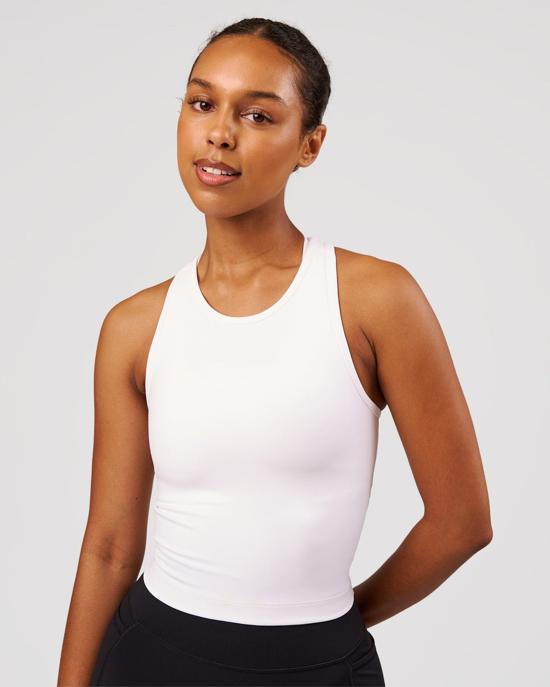 Woman wearing Flow Performance Tank 2.0 - White | Model:Jordan | Size:S - view 1