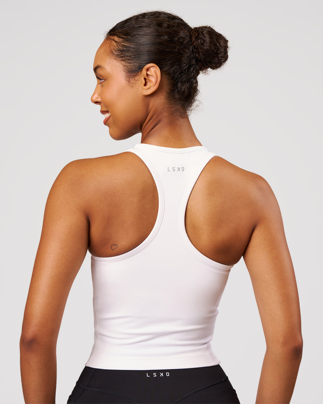 Woman wearing Flow Performance Tank 2.0 - White | Model:Jordan | Size:S - view 3