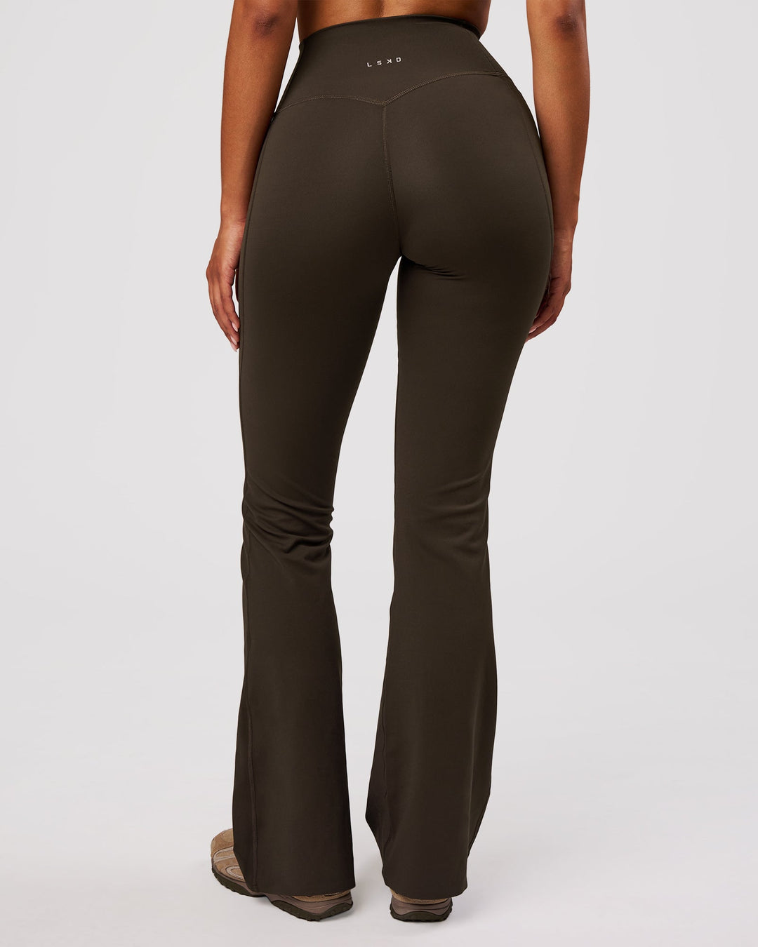 Woman wearing Fusion V-Contour High-Rise Flared Legging Pockets - Ground Coffee | Model:Jordan | Size:S - view 2