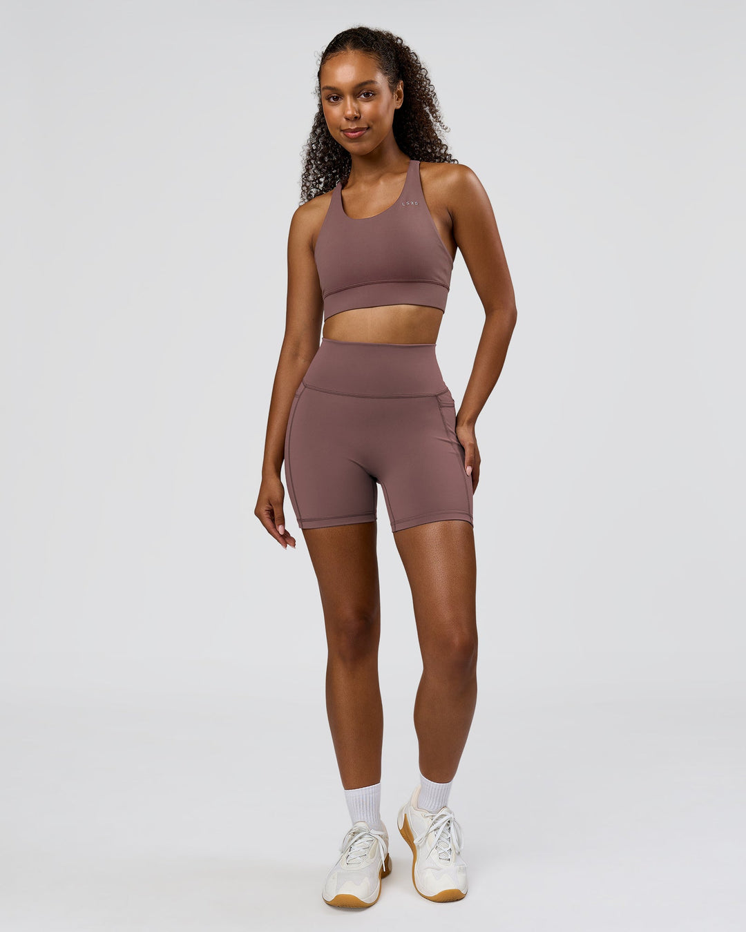 Woman wearing Fusion V-Contour Ultra High-Rise 6" Short Pockets - Cocoa Powder | Model:Jordan | Size:S - view 7