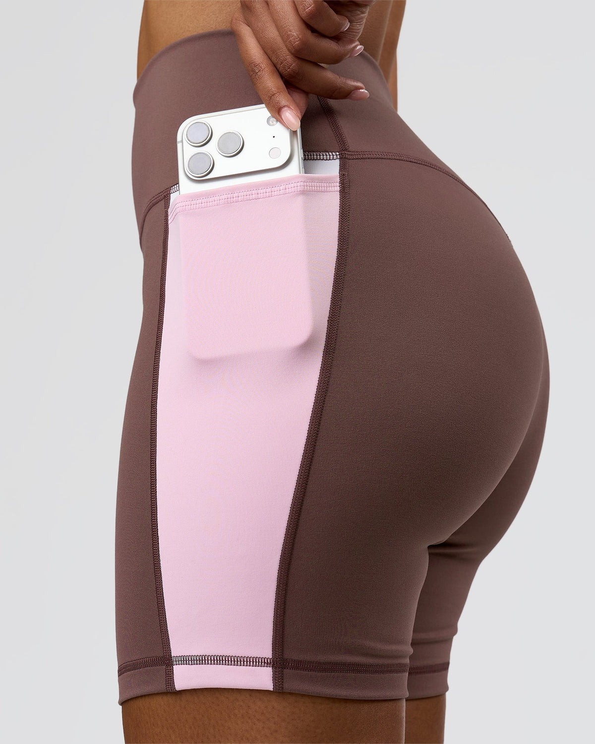 Woman wearing Fusion V-Contour Ultra High-Rise 6" Short Pockets - Cocoa Powder-Marshmallow-White | Model:Jordan | Size:S - view 1