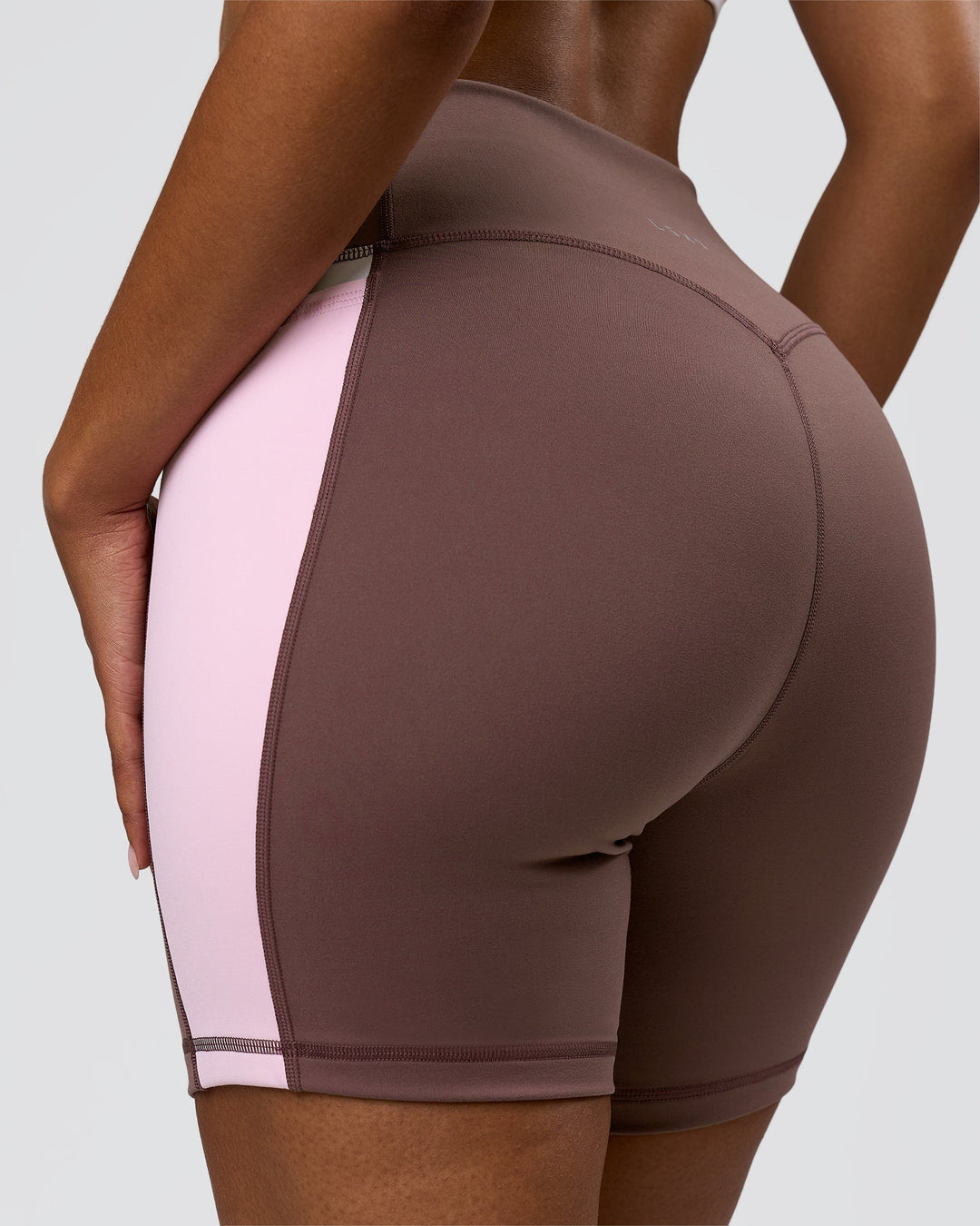 Woman wearing Fusion V-Contour Ultra High-Rise 6" Short Pockets - Cocoa Powder-Marshmallow-White | Model:Jordan | Size:S - view 5