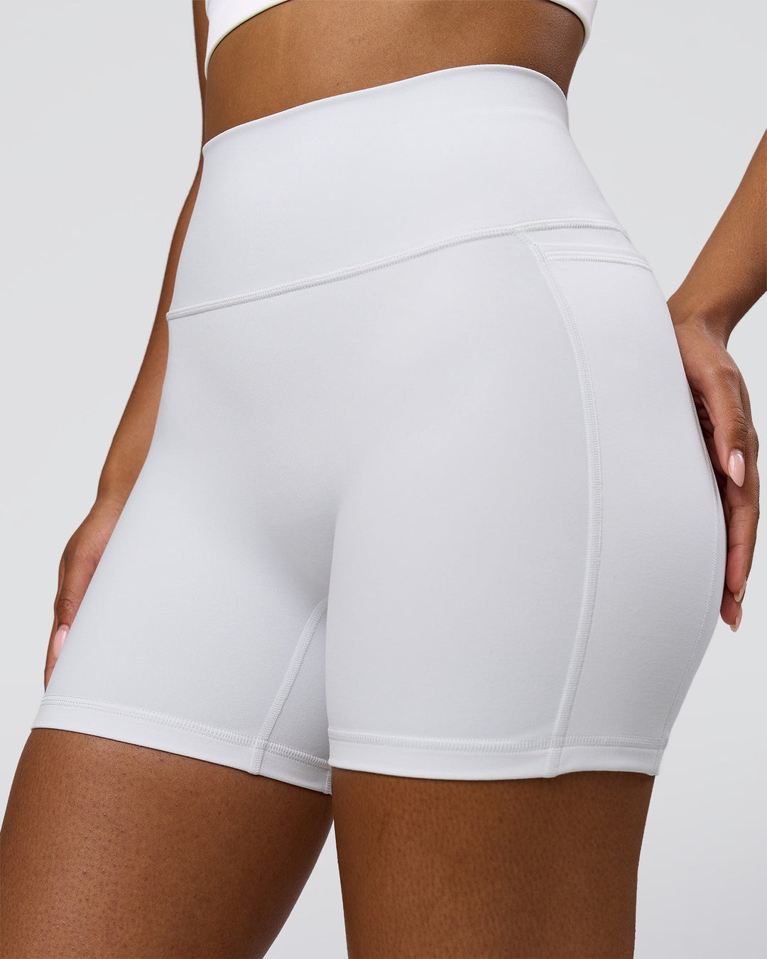 Woman wearing Fusion V-Contour Ultra High-Rise 6" Short Pockets - White | Model:Jordan | Size:S - view 3