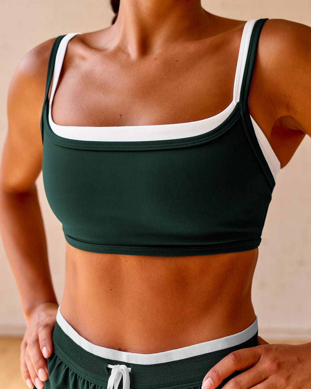 Woman wearing Balance Sports Bra - Midnight Green-White | Model:Meg | Size:S - view 1
