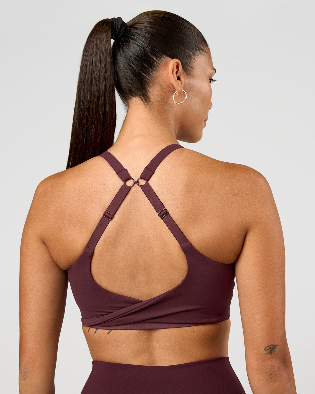 Woman wearing Twist Sports Bra D/DD/E - Cherry Lacquer | Model:Rhiley | Size:S - view 1
