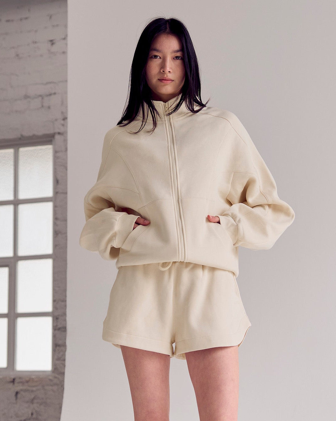 Woman wearing Bree Fleece Track Short - Vanilla Bean | Model:Rianna | Size:S - view 2