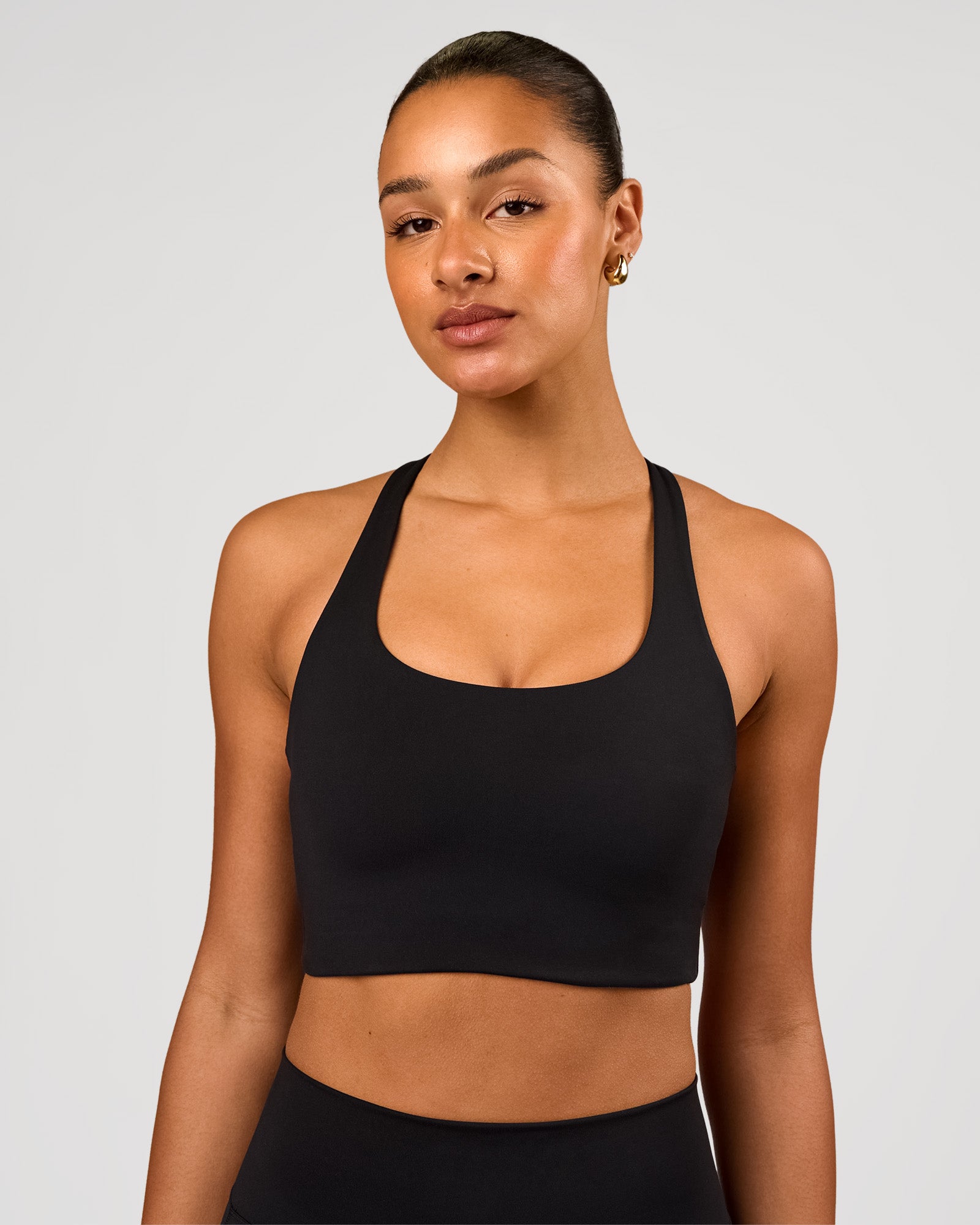 Woman wearing Flow Long Line Sports Bra - Black | Model:Rosie | Size:S