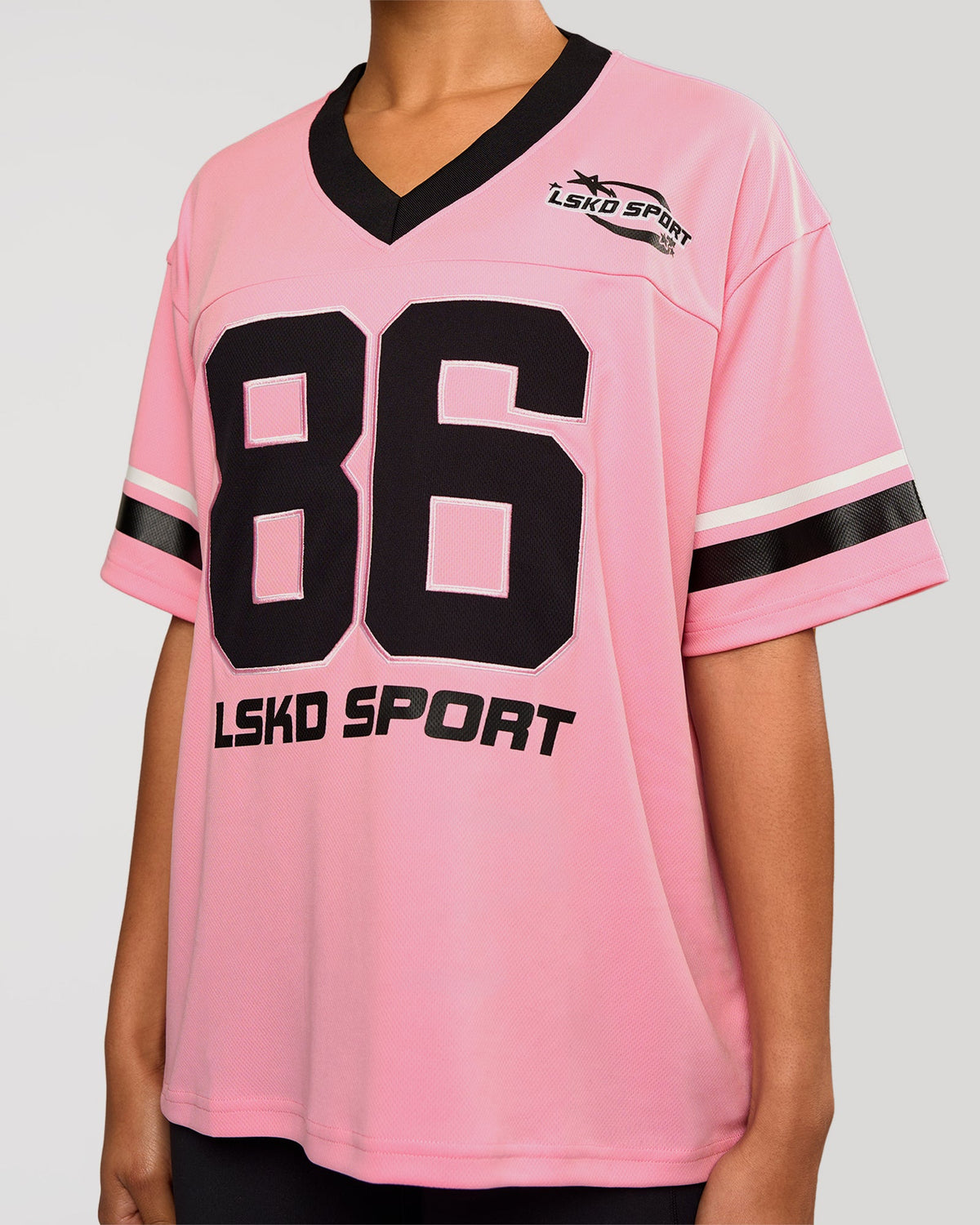 Woman wearing Playmaker V-Neck Jersey - Pink Rose-Black | Model:Rosie | Size:S