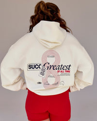 Woman wearing Greatest of All Time Heavyweight Oversized Hoodie - Off White | Model:Tia | Size:S | Thumbnail Index: 4