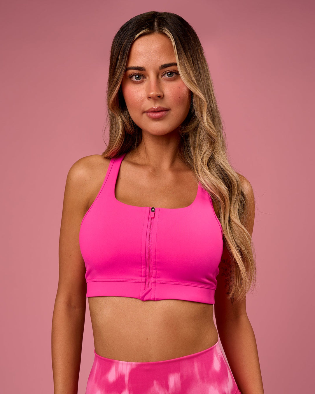 Woman wearing Empowered Sports Bra - Ultra Pink | Model:Tianah | Size:S - view 1