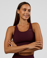 Woman wearing Accelerate Sports Bra - Cherry Lacquer | Model:Brylee | Size:XS | Thumbnail Index: 2