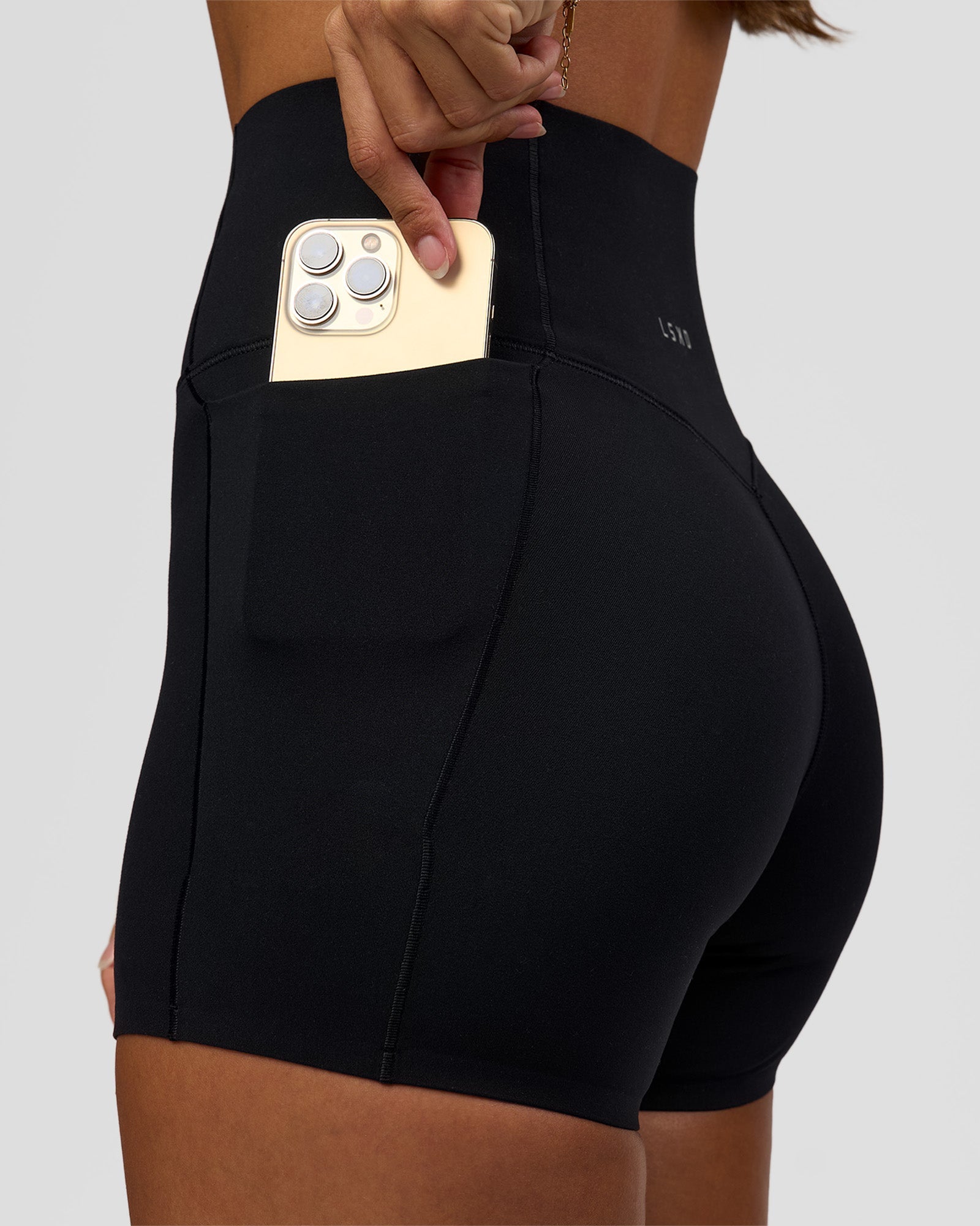 Woman wearing Fusion Bonded High-Rise 4" Short Pockets - Black | Model:Brylee | Size:XS