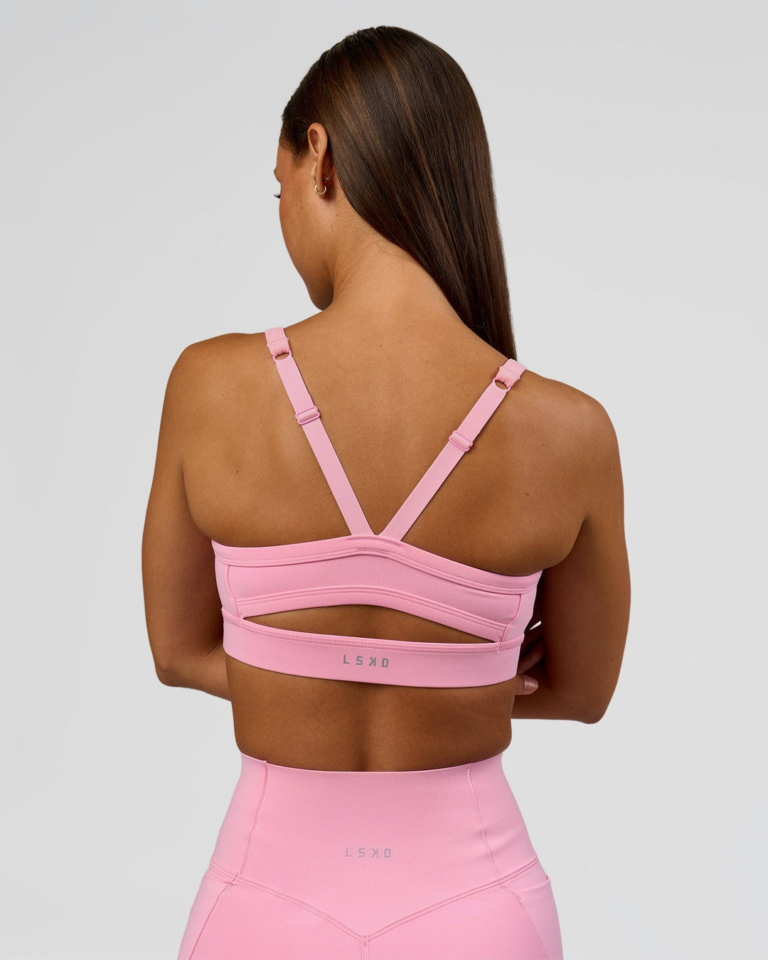 Woman wearing Momentum Sports Bra - Pink Rose | Model:Brylee | Size:XS - view 3