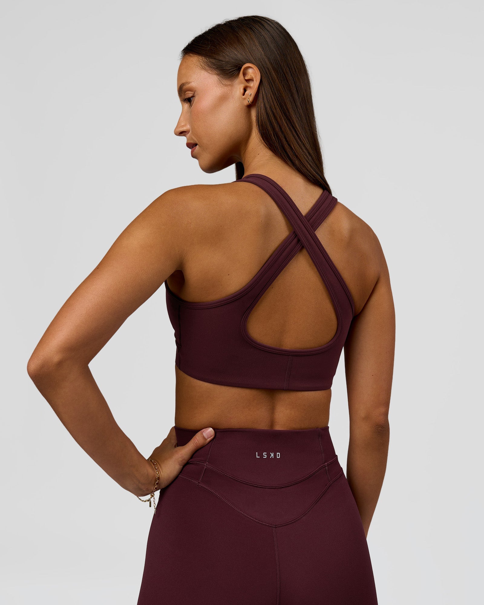 Woman wearing Stamina Sports Bra - Cherry Lacquer | Model:Brylee | Size:XS